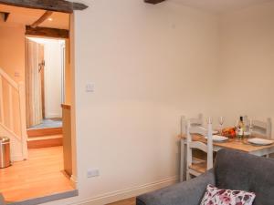 a living room with a couch and a table at Pinner's Cottage in Knighton