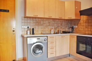 a kitchen with a washing machine in a kitchen at Raise Cosy Studio with pool in Limassol in Limassol