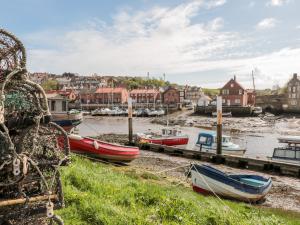 a group of boats are docked in a harbor at Crossing Cottage in Whitby