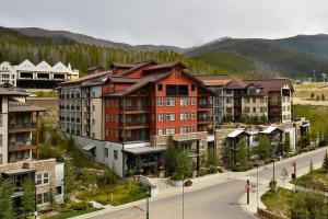 a group of buildings on a street with a mountain at Ski In-Out Luxury Condo #4474 With Huge Hot Tub & Great Views - 500 Dollars Of FREE Activities & Equipment Rentals Daily in Winter Park