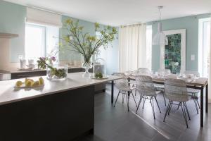 a kitchen with a dining table and chairs at La Bourgeoise in Portbail