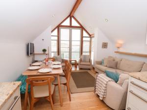 a kitchen and living room with a table and chairs at 5 Harbour Yard in Salcombe