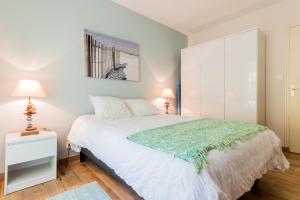 a bedroom with a white bed and a white cabinet at T2 Port de Vannes in Vannes +15 photos