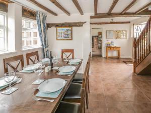 a dining room with a long table and chairs at The Farmhouse in Ledbury