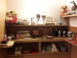 a shelf with food and other items on it at Casa Salvaterra Affittacamere in Pinzolo