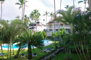 a view of a resort with palm trees and a pool at Little paradise in middle of beautiful beaches! in Las Terrenas