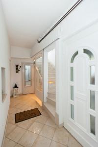 ein Flur mit einer Tür und einem Fliesenboden in der Unterkunft Promaja in Kaštela