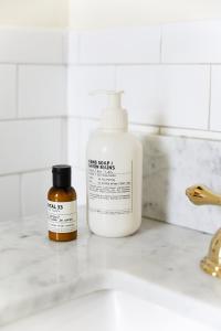 a bottle of liquid soap next to a bathroom sink at Life House, Little Havana in Miami