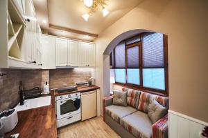 a living room with a couch in a kitchen at Apartment AlPreMira in Varna City +36 photos