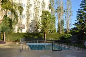 a building with a swimming pool in front of a building at Raise Cosy Studio with pool in Limassol in Limassol