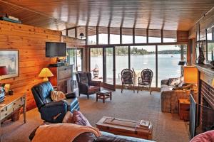 a living room with a view of the water at Newport Cabin with Lakefront Private Porch and Grill! in Newport