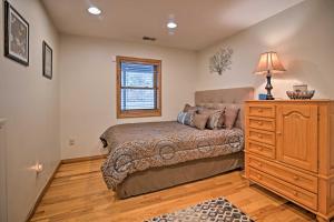 a bedroom with a bed and a dresser and a window at Riverfront Elkins Home with Fireplace and Deck! in Elkins