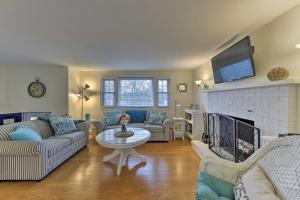 a living room with couches and a fireplace with a tv at Pond Access and Private Dock East Wareham Home in East Wareham