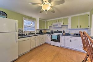 a kitchen with white appliances and a ceiling fan at Pond Access and Private Dock East Wareham Home in East Wareham