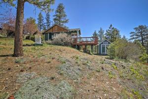 a house on top of a hill at Walk to Lake Cabin with Deck and Views in Fawnskin in Fawnskin