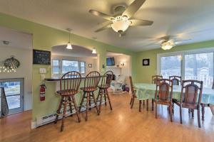 a dining room and kitchen with a table and chairs at Pond Access and Private Dock East Wareham Home in East Wareham