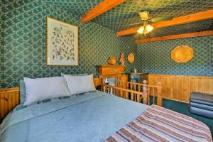 a bedroom with a bed and a ceiling fan at Walk to Lake Cabin with Deck and Views in Fawnskin in Fawnskin