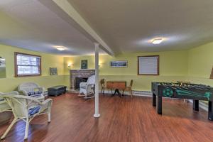 a living room with a ping pong table and chairs at Pond Access and Private Dock East Wareham Home in East Wareham