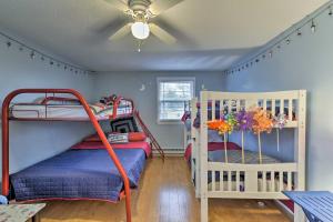 two bunk beds in a room with blue walls at Pond Access and Private Dock East Wareham Home in East Wareham