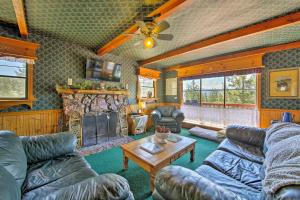 a living room with couches and a fireplace at Cabin with Deck and Views Steps from Big Bear Lake in Fawnskin