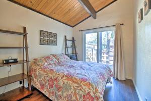 a bedroom with a bed and a large window at Cozy Cabin with Deck and Fireplace in Big Bear! in Big Bear City