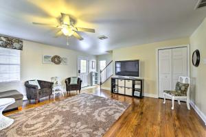 a living room with a ceiling fan and a flat screen tv at Breezy Ocean City Home Walk to Beach and Boardwalk! in Ocean City