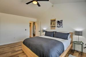 a bedroom with a large bed with a ceiling fan at Updated Mesa Home with Spacious Backyard and Fire Pit! in Mesa