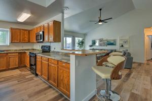 a large kitchen with wooden cabinets and a counter top at Updated Mesa Home with Spacious Backyard and Fire Pit! in Mesa