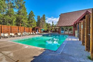 a swimming pool with chairs and a house at Deck and Spa Access Modern Breckenridge Condo! in Breckenridge