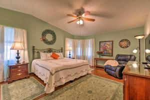 a bedroom with a bed and a ceiling fan at Lovely Lady Lake Home with Resort Amenities and Lanai! in Lady Lake +16 photos