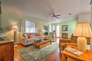 a living room with a couch and a table at Lovely Lady Lake Home with Resort Amenities and Lanai! in Lady Lake