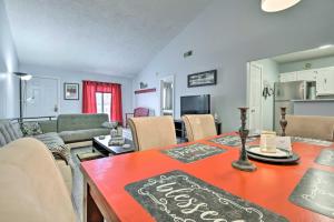 a dining room and living room with a table and chairs at Mount Pocono Condo with Balcony - Near Mt Airy Casino in Mount Pocono