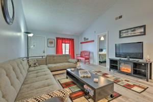 a living room with a couch and a tv at Near Mt Airy Casino Mount Pocono Condo with Balcony in Mount Pocono