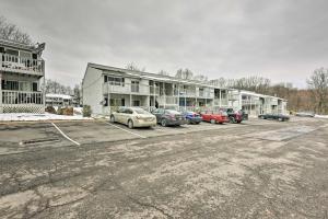 a parking lot with cars parked in front of a building at Near Mt Airy Casino Mount Pocono Condo with Balcony in Mount Pocono
