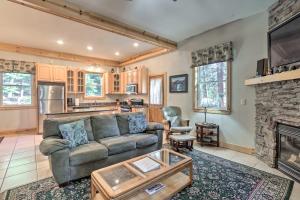 a living room with a couch and a fireplace at Carnelian Bay Home with Hot Tub Near Tahoe Skiing in Carnelian Bay