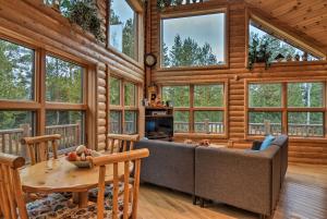 eine Blockhütte mit einem Sofa und einem Tisch in der Unterkunft Camp Tony with Trail Access Walk to Lake Huron! in High Banks
