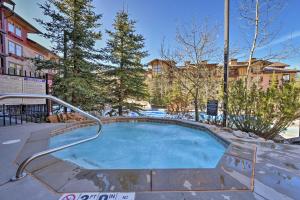 a hot tub with a hand rail in a yard at Solitude Creekside Condo-Closest to Ski Lift! in Solitude