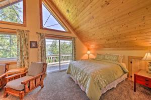 a bedroom with a bed and a wooden ceiling at Lakeside Sagle Home with Dock-by Schweitzer Mtn! in Sagle