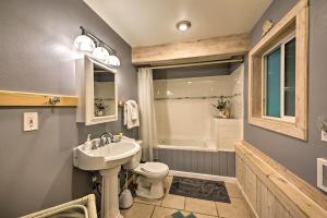 a bathroom with a sink and a toilet and a tub at Lakeside Sagle Home with Dock-by Schweitzer Mtn! in Sagle +26 photos