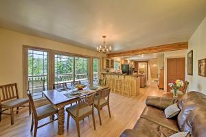 a living room with a table and a couch at Lakeside Sagle Home with Dock-by Schweitzer Mtn! in Sagle