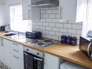 a kitchen with a stove and a counter top at Flat 1 in Bridlington