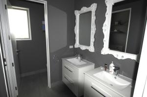 a white bathroom with a sink and a mirror at Deb's Place in Swannanoa