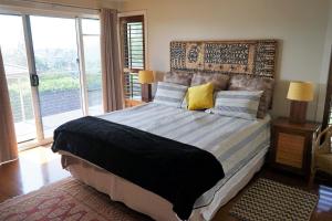 a bedroom with a large bed with a large window at Villa with Views & Pool in Gold Coast +26 photos