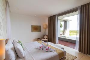 Voodi või voodid majutusasutuse Svarga Resort Lombok toas