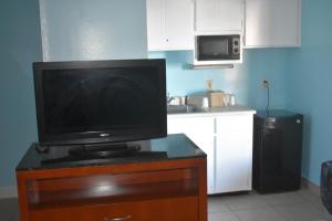 a kitchen with a microwave and a refrigerator at Guest Cottages & Suites in Brunswick