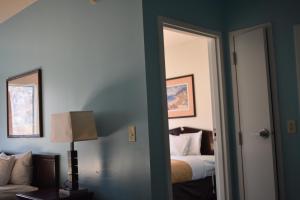 a bedroom with a bed and a window at Guest Cottages & Suites in Brunswick