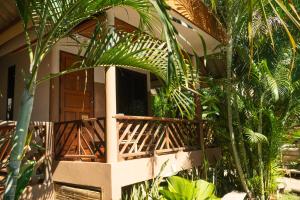 a porch of a house with plants in front of it at Chilling Hill Guesthouse in Pai