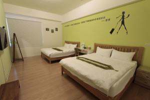 Postel nebo postele na pokoji v ubytování Jin Du Yi Yuan B & B
