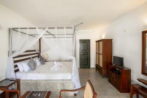 a bedroom with a bed with a chicken on it at Villa Nilnara in Ahungalla