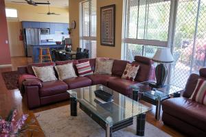 a living room with a couch and a table at Villa with Views & Pool in Gold Coast